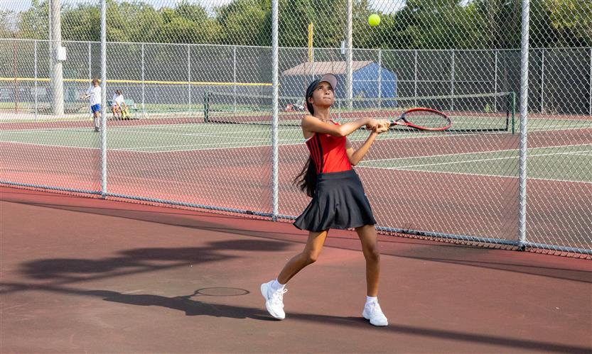 A tennis player hits the ball